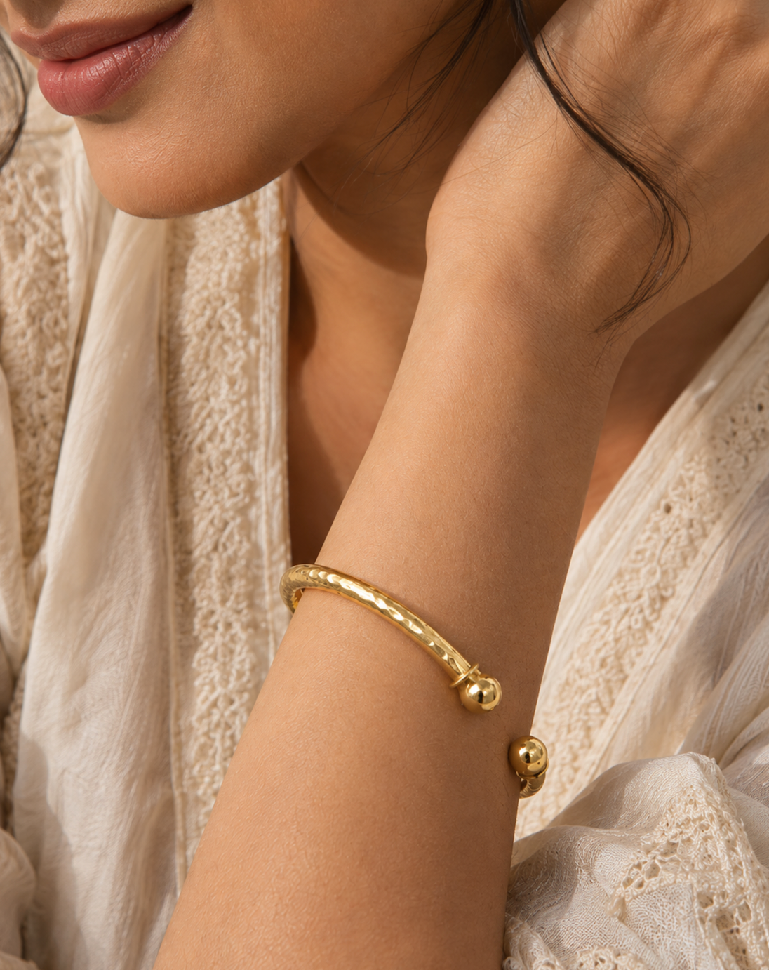 Close up of women wearing Punarv hand hammered brass kada. It has adjustable opening. 